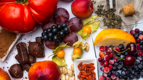 Colorful spread of antioxidant-rich foods like berries, nuts, and dark chocolate.
